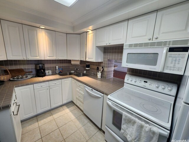 2500 Kalakaua Ave Unit 201, Honolulu, HI 96815 - kitchen with white cabinetry, tile countertops, a sink, and white appliances