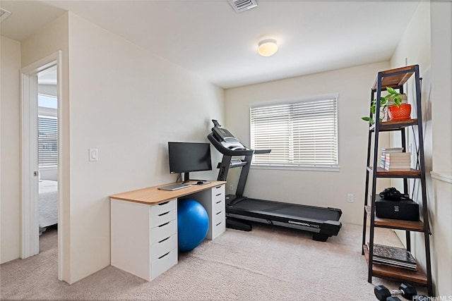 exercise area featuring light carpet and visible vents