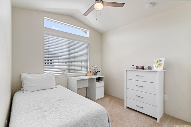 bedroom featuring a ceiling fan, light carpet, and vaulted ceiling
