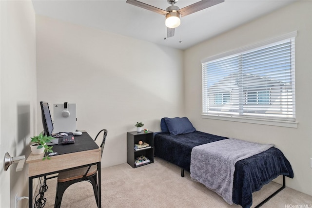 bedroom with ceiling fan and light carpet