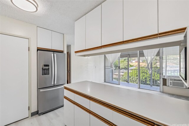 1687 Pensacola St Unit 804, Honolulu, HI 96822 - kitchen featuring stainless steel fridge with ice dispenser, white cabinets, cooling unit, light countertops, and a textured ceiling