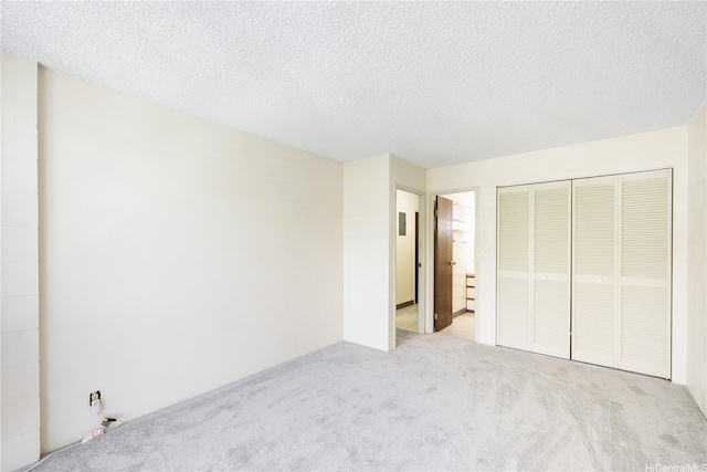 1687 Pensacola St Unit 804, Honolulu, HI 96822 - unfurnished bedroom featuring carpet flooring, a closet, and a textured ceiling