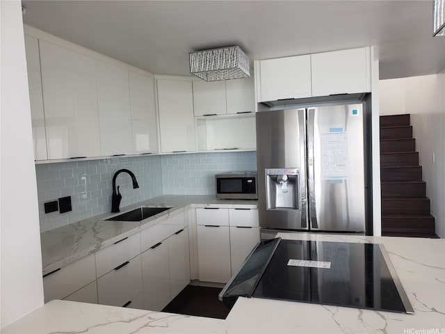98-288 Kaonohi St Unit 4401, Aiea, HI 96701 - kitchen with appliances with stainless steel finishes, backsplash, white cabinetry, light stone countertops, and modern cabinets