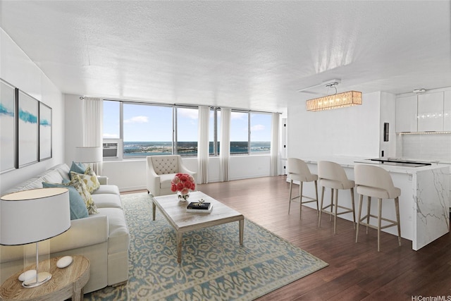 98-288 Kaonohi St Unit 4401, Aiea, HI 96701 - living room featuring plenty of natural light, dark wood-style floors, a textured ceiling, and a chandelier