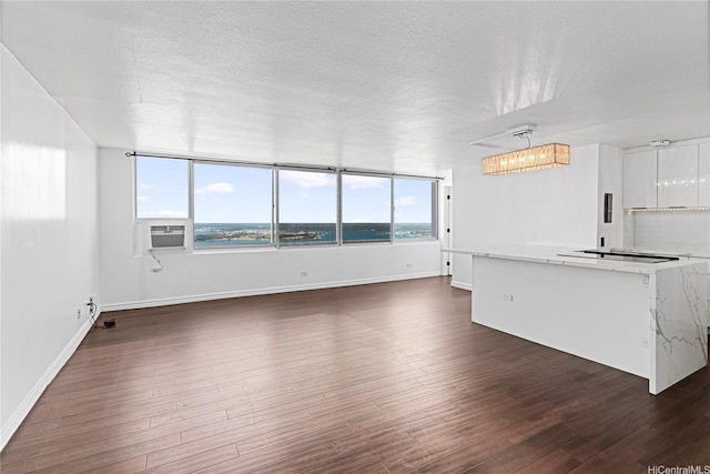 98-288 Kaonohi St Unit 4401, Aiea, HI 96701 - unfurnished living room featuring cooling unit, dark wood-style floors, a chandelier, and a textured ceiling
