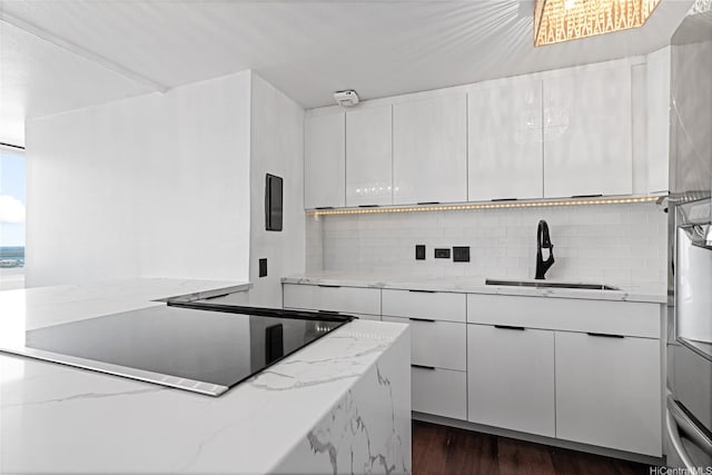 98-288 Kaonohi St Unit 4401, Aiea, HI 96701 - kitchen with black electric cooktop, decorative backsplash, modern cabinets, and white cabinetry