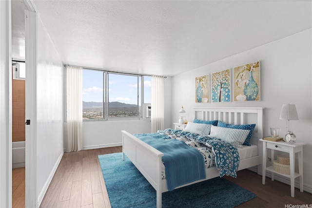 98-288 Kaonohi St Unit 4401, Aiea, HI 96701 - bedroom featuring wood finished floors, a mountain view, and a textured ceiling