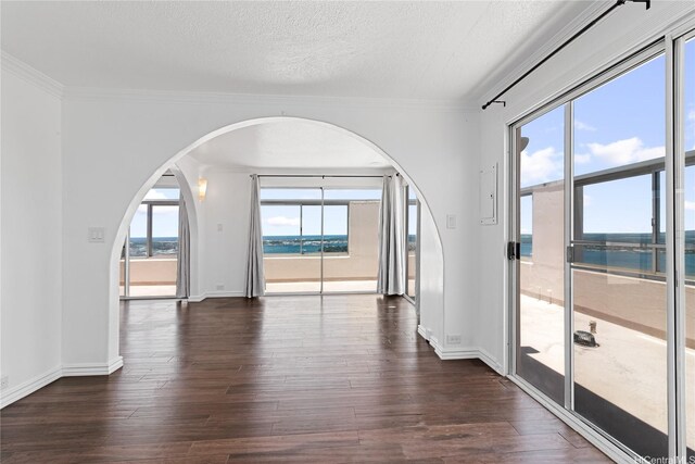 98-288 Kaonohi St Unit 4401, Aiea, HI 96701 - spare room featuring dark wood-style flooring, arched walkways, a textured ceiling, a water view, and crown molding