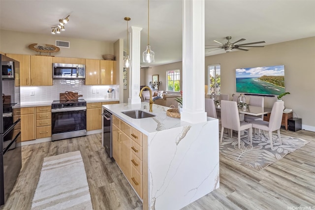 92-6127 Puapake St, Kapolei, HI 96707 - kitchen with appliances with stainless steel finishes, a sink, light brown cabinetry, light wood-style floors, and tasteful backsplash