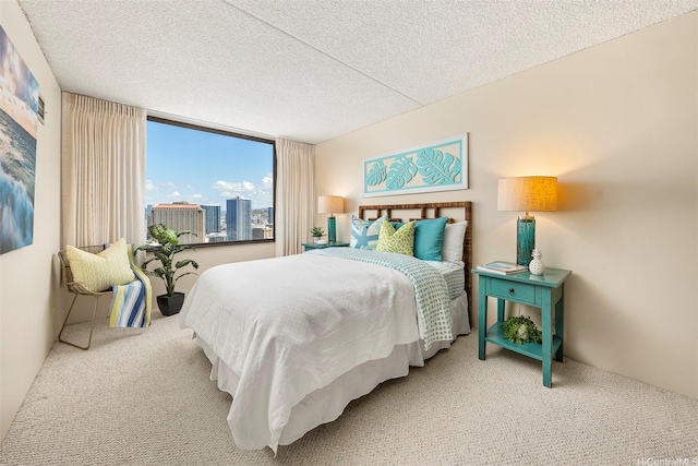 carpeted bedroom featuring a textured ceiling