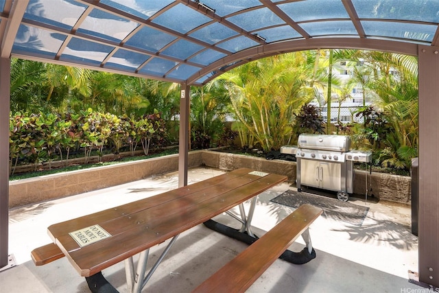 view of patio with a grill and a pergola