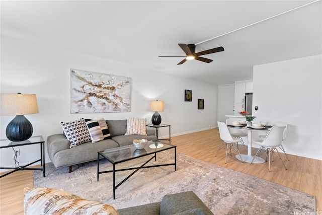 95-2031 Waikalani Pl Unit D306, Mililani, HI 96789 - living area with a ceiling fan, light wood-style floors, and baseboards
