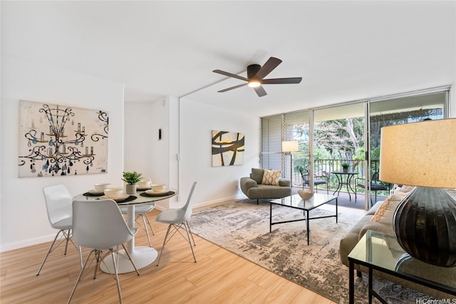 95-2031 Waikalani Pl Unit D306, Mililani, HI 96789 - living area featuring a ceiling fan, wood finished floors, baseboards, and a wall of windows