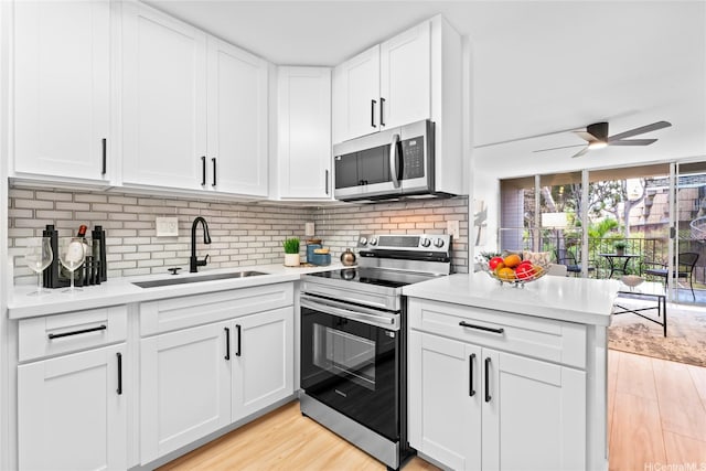 95-2031 Waikalani Pl Unit D306, Mililani, HI 96789 - kitchen featuring appliances with stainless steel finishes, a sink, light countertops, and a ceiling fan