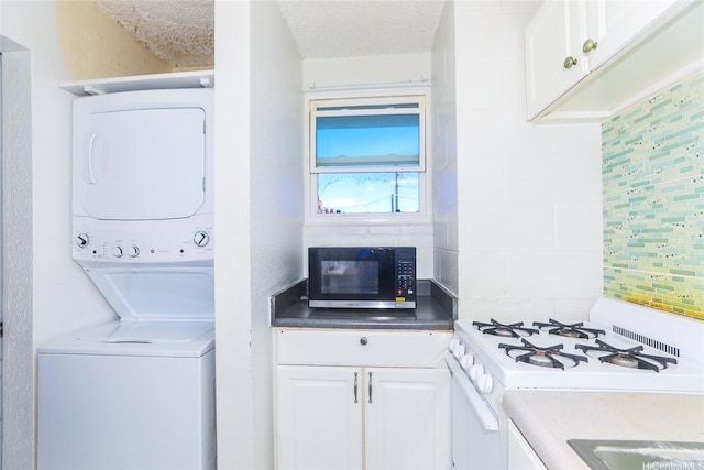 laundry room with stacked washer and clothes dryer and a textured ceiling