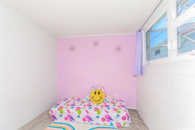 unfurnished bedroom with a textured ceiling and carpet