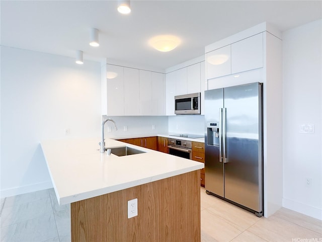 629 Keeaumoku St Unit 2205, Honolulu, HI 96814 - kitchen with stainless steel appliances, modern cabinets, a sink, a peninsula, and light countertops