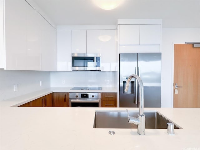 629 Keeaumoku St Unit 2205, Honolulu, HI 96814 - kitchen featuring a sink, stainless steel appliances, white cabinets, modern cabinets, and light countertops