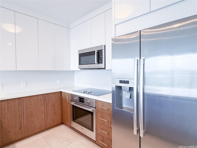 629 Keeaumoku St Unit 2205, Honolulu, HI 96814 - kitchen featuring brown cabinets, white cabinetry, light countertops, modern cabinets, and appliances with stainless steel finishes