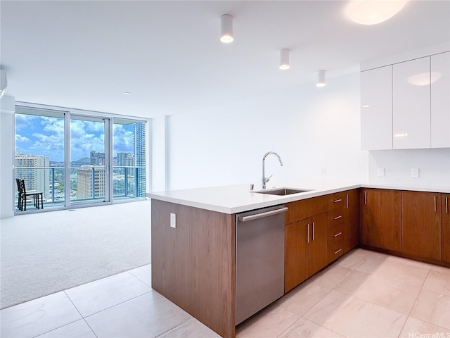 629 Keeaumoku St Unit 2205, Honolulu, HI 96814 - kitchen with a peninsula, a sink, white cabinets, stainless steel dishwasher, and light colored carpet