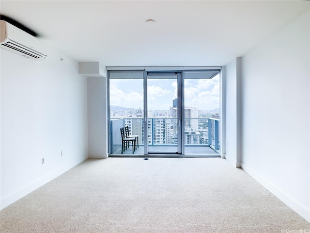 629 Keeaumoku St Unit 2205, Honolulu, HI 96814 - spare room with a wall mounted air conditioner, floor to ceiling windows, baseboards, and carpet floors