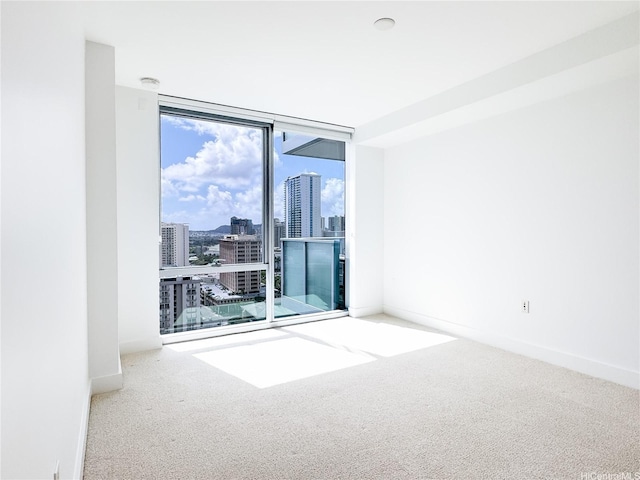629 Keeaumoku St Unit 2205, Honolulu, HI 96814 - carpeted spare room featuring a city view, baseboards, and a healthy amount of sunlight
