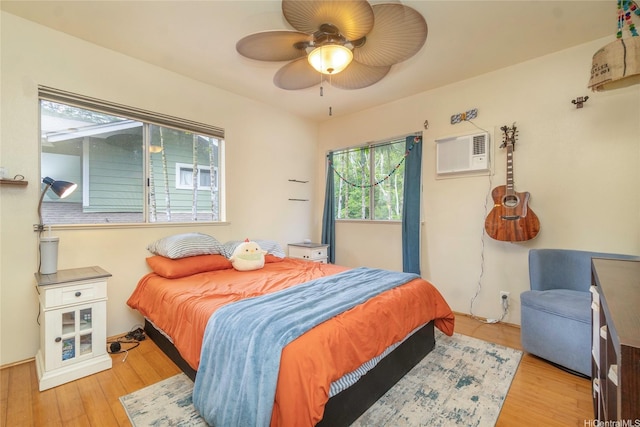 95-1007 Wikao St Unit 29, Mililani, HI 96789 - bedroom featuring a ceiling fan, a wall mounted AC, and wood finished floors