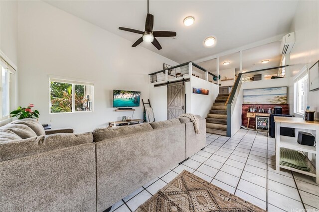625 Maluniu Ave, Kailua, HI 96734 - living area with a barn door, a wall unit AC, light tile patterned floors, ceiling fan, and stairs