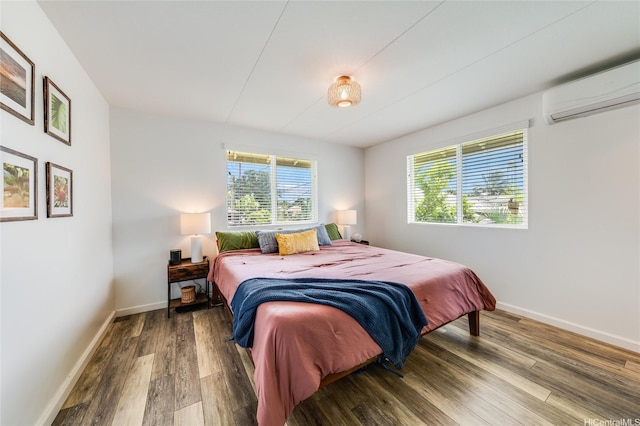 625 Maluniu Ave, Kailua, HI 96734 - bedroom with a wall mounted air conditioner, wood finished floors, and baseboards