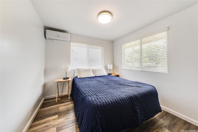 625 Maluniu Ave, Kailua, HI 96734 - bedroom with a wall unit AC, wood finished floors, and baseboards