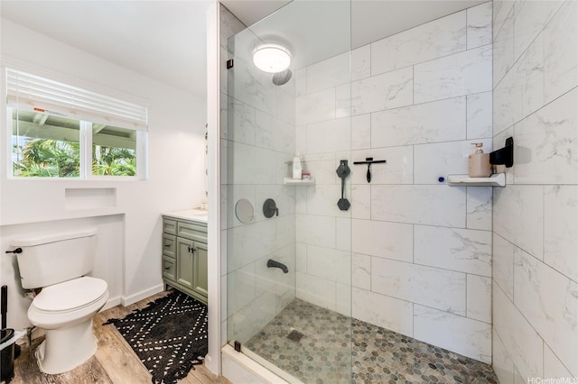625 Maluniu Ave, Kailua, HI 96734 - full bath with a tile shower, toilet, wood finished floors, vanity, and baseboards
