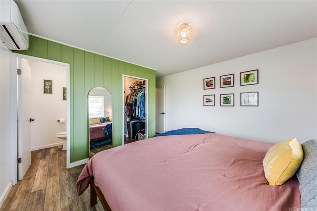 625 Maluniu Ave, Kailua, HI 96734 - bedroom with wood finished floors, an AC wall unit, a closet, and ensuite bath