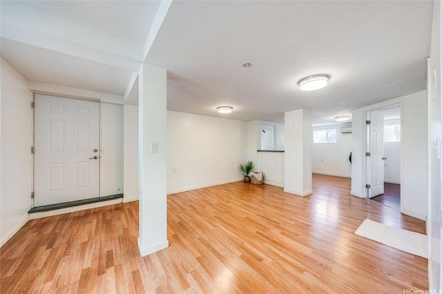 625 Maluniu Ave, Kailua, HI 96734 - basement featuring light wood-style flooring, baseboards, and a wall mounted AC