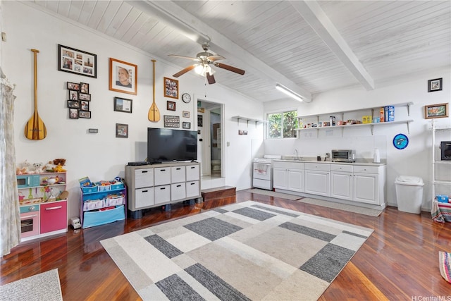 bedroom with a sink, beamed ceiling, a toaster, and wood finished floors