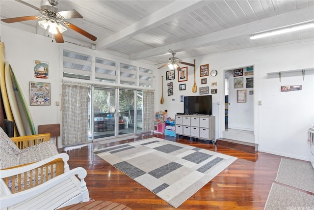 living room with beamed ceiling, a ceiling fan, and wood finished floors