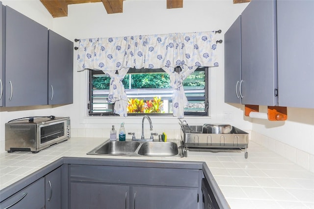 45-995 Wailele Rd Unit 8, Kaneohe, HI 96744 - kitchen featuring a sink, tile counters, and gray cabinets