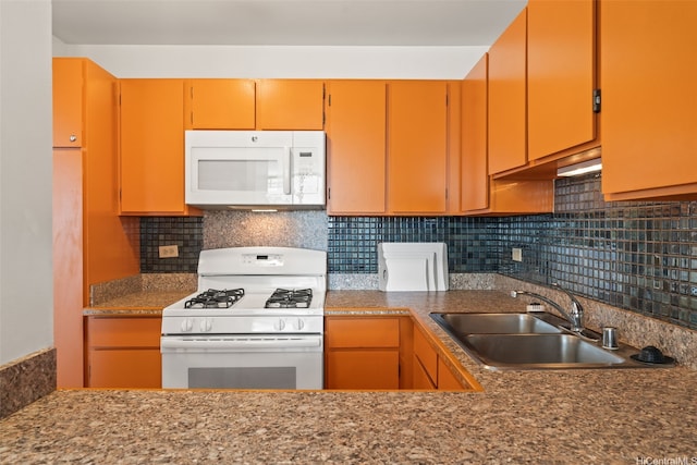 kitchen with decorative backsplash, a sink, and white appliances