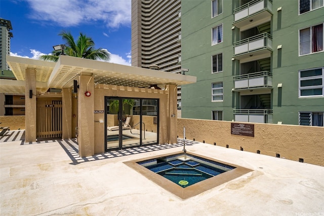view of pool with a hot tub