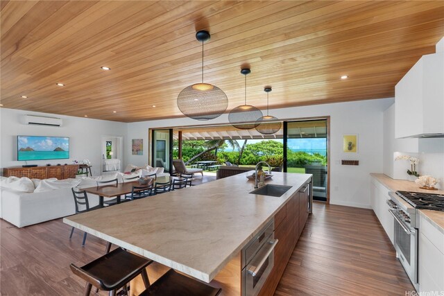 21 Kalaka Pl, Kailua, HI 96734 - kitchen featuring a sink, a wall unit AC, appliances with stainless steel finishes, wooden ceiling, and white cabinetry