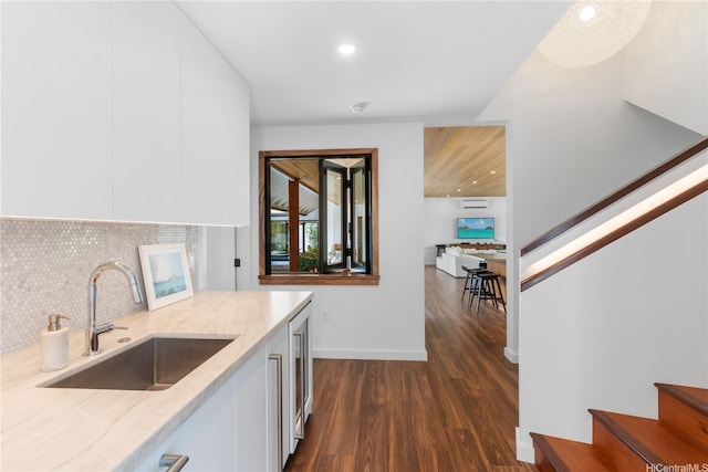 21 Kalaka Pl, Kailua, HI 96734 - kitchen featuring a sink, light stone counters, dark wood-type flooring, decorative backsplash, and white cabinetry
