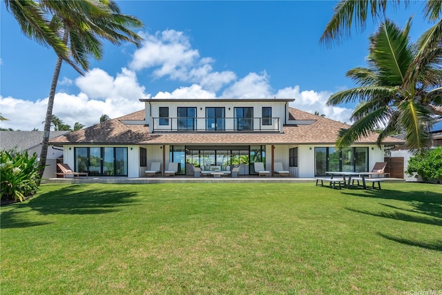 21 Kalaka Pl, Kailua, HI 96734 - back of house featuring an outdoor living space, a balcony, a shingled roof, and a lawn