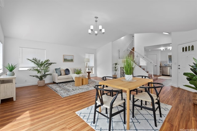 91-113 Kaakina Pl, Ewa Beach, HI 96706 - dining area featuring stairway, lofted ceiling, a chandelier, and wood finished floors