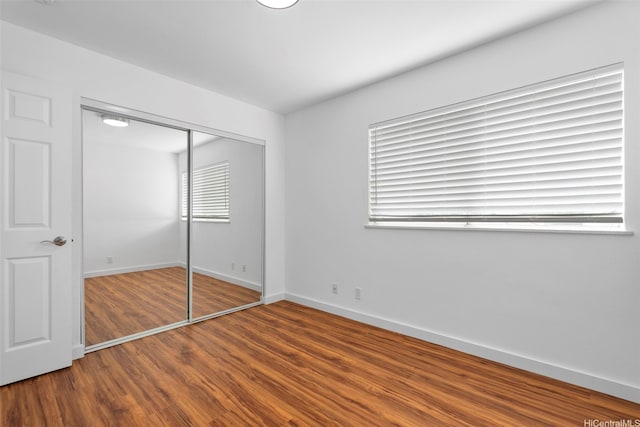 91-113 Kaakina Pl, Ewa Beach, HI 96706 - unfurnished bedroom with wood finished floors, a closet, and baseboards
