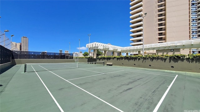 view of tennis court with fence