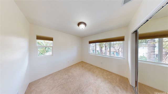 91-1040 Kaihohonu St, Ewa Beach, HI 96706 - unfurnished bedroom with multiple windows, carpet floors, and a closet