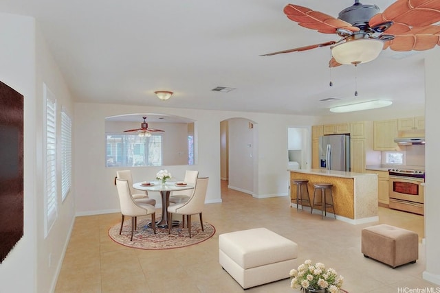 91-1040 Kaihohonu St, Ewa Beach, HI 96706 - dining space featuring ceiling fan, arched walkways, baseboards, and light tile patterned floors
