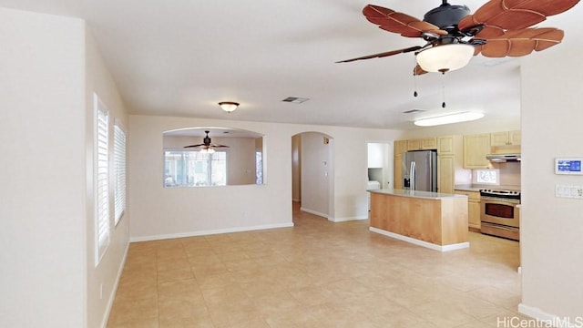91-1040 Kaihohonu St, Ewa Beach, HI 96706 - kitchen featuring appliances with stainless steel finishes, ceiling fan, light countertops, under cabinet range hood, and arched walkways