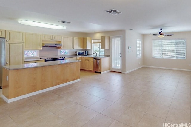 91-1040 Kaihohonu St, Ewa Beach, HI 96706 - kitchen featuring stainless steel appliances, under cabinet range hood, light countertops, light brown cabinetry, and a center island