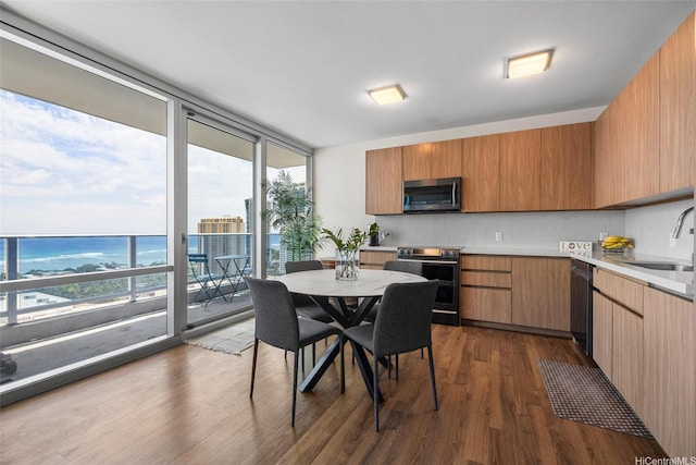 1391 Kapiolani Blvd Unit 2512, Honolulu, HI 96814 - kitchen featuring appliances with stainless steel finishes, a sink, dark wood-style flooring, light countertops, and floor to ceiling windows