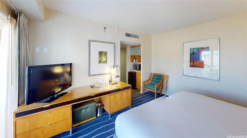 bedroom featuring dark colored carpet and visible vents